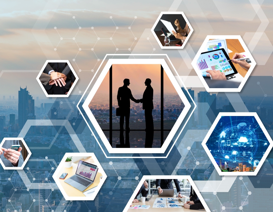 A collection of images in hexagons. The largest one is in the center and contains two shadowed businesspeople shaking hands. The other hexagons contain a person's hand and a tablet showing graphs, a blue sphere with various icons surrounding it (such as a cloud, a phone, a home icon, etc.), a meeting table with graphs on it and three people sitting around it, a computer showing graphs, a person holding cellphone, a group of people in suits putting their hands on top of each other, and a person holding up a stack of papers and a pen.